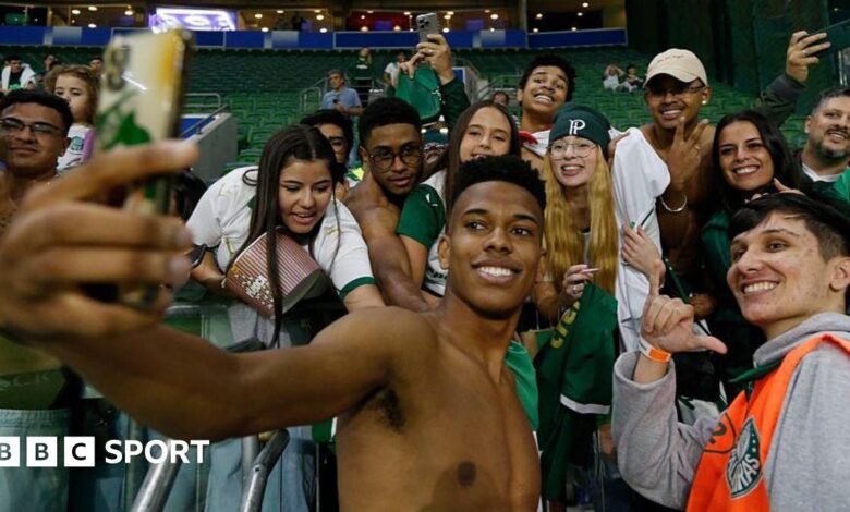Estevao Willian poses for a selfie with a group of Palmeiras fans