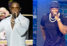 Ja Rule in a white shirt performing, and 50 Cent in a black shirt and cap, both holding microphones on stage.