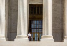 A guard on the Supreme Court steps